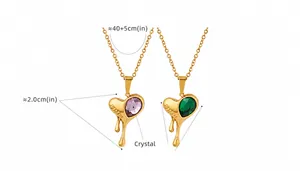 Detail of melting heart pendant with pink and green crystals and DREAM engraving