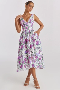 Detail showing side hidden pockets and floral print on white sleeveless V-neck dress