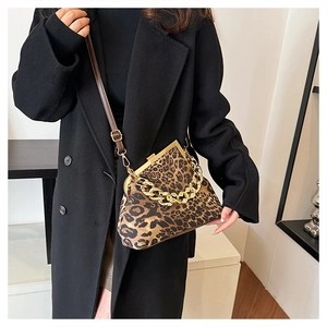 Detail of leopard print shell bag with chunky gold chain and vintage metal clasp closure