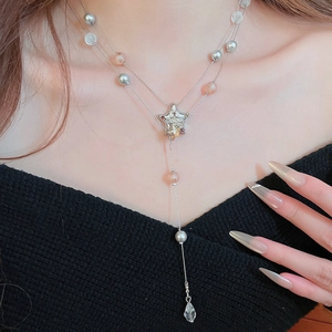 Detail of double-layer silver star necklace with colorful pearls and crystal water drop