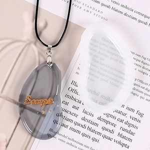 Detailed view of Scorpio zodiac resin pendant with gold foil and minimalist cord