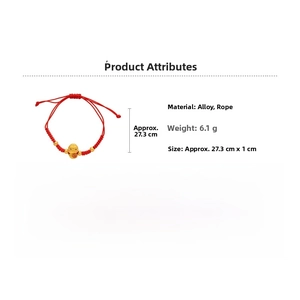 Detail of red woven cord bracelet with golden lucky coin pendant and engraved charms