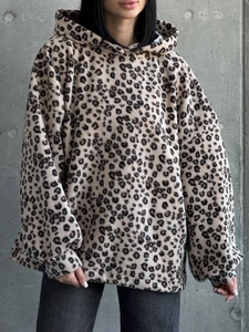 Detailed view of leopard print texture on thick oversized polar fleece hoodie with pockets