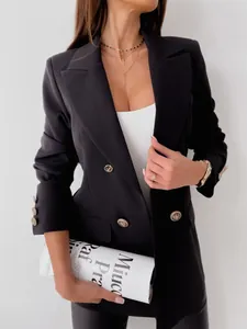 Detailed close-up of golden embossed buttons on a classic black double-breasted blazer