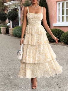 Full view of elegant floral tiered dress with ruffles and smocked detail in outdoor setting