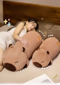Detailed view of plush capybara pillows with lucky embroidery in a cozy bedroom setting