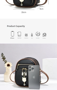 Detail view of mini black leather bag with cat pendant showing 16cm width and 9cm thickness