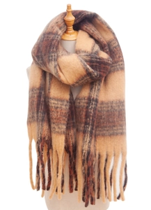 Detail of soft thick plaid scarf with camel brown tones and fringe ends on a wooden mannequin