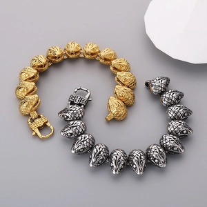 Detailed macro view of 21mm punk snake head bracelet in gold and silver steel finish