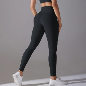 Close-up of black high-waisted yoga pants with lift-up seams and matte fabric texture