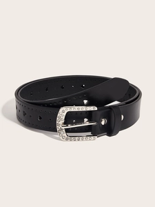 Detail of black leather belt with silver rhinestone buckle and heart-shaped cutouts