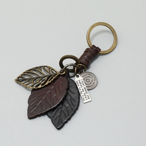 Vintage braided leather leaf keychain with bronze metal ring and engraved charm