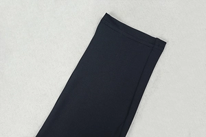 Close-up of double-needle stitching on black sporty bodysuit cuff with premium texture