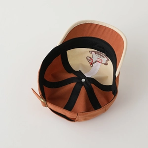 Detail view of the embroidered pony design inside a color-block baseball cap for kids