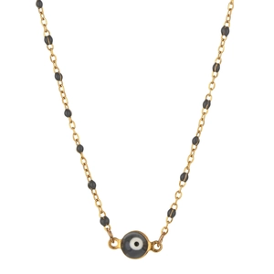 Close-up of golden stainless steel chain featuring black beads and evil eye pendant detail