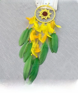 Detail of handcrafted sunflower dreamcatcher with yellow feathers and woven sunflower core
