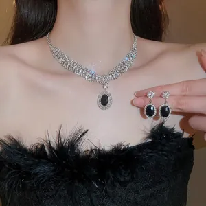 Elegant silver necklace and earring set with oval black stone and white rhinestones