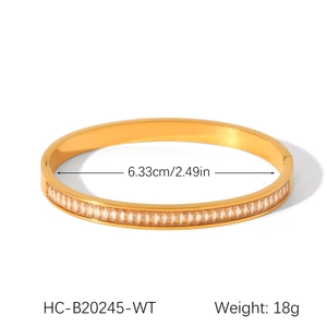 Macro detail of gold stainless steel bangle showing 6.33cm diameter and 18g weight