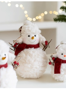 Detailed view of plush snowman ornament featuring red knit scarf and berry accents
