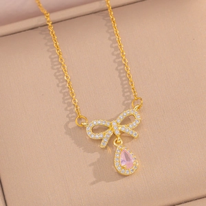 Detail of bow pendant necklace with pink teardrop crystal and cubic zirconia accents