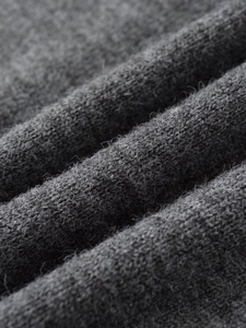 Macro shot of grey ribbed knit fabric showing soft texture and detailed weaving pattern