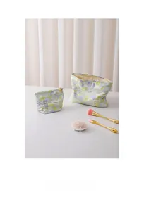 Detailed view of floral makeup bags in two sizes with soft fabric and secure zippers