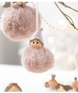 Detailed close-up of a plush pink angel girl ornament with soft textures and silver accents