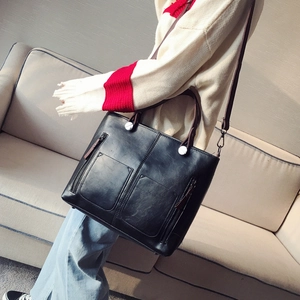 Vintage black oil leather tote bag for women with dual handles and adjustable strap