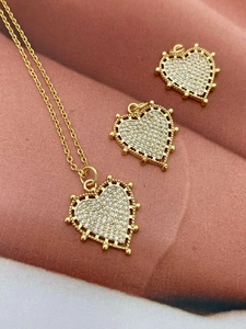 Close-up of 18K gold-plated heart necklace with sparkling zircon pavé on velvet background