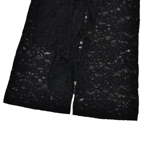 Close-up of intricate black lace fabric texture and floral pattern on a slim bodysuit