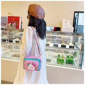 Detail of cute unicorn crossbody bag featuring colorful straps and patchwork design