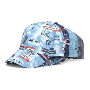 Detail of stacked blue and white tie-dye denim baseball caps with graffiti print