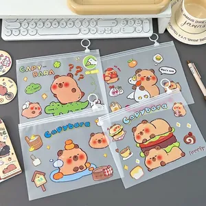 Set of 4 transparent Capybara cartoon pencil cases with slider zipper closure on desk