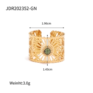 Detail of gold hollow-out ring featuring a green natural stone with size measurements