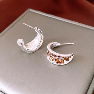 Vintage silver C-shaped drop earrings with orange amber-style enamel patterns