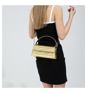 Detailed back view of a model carrying a gold crocodile texture quilted tote handbag
