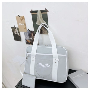 Close-up of heart-shaped transparent window on a light grey JK uniform ita bag