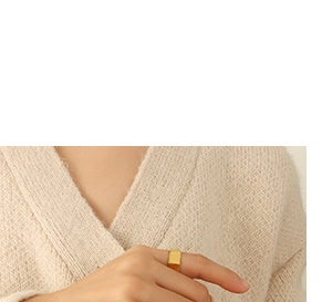 Close-up of a minimalist 18K gold plated square signet ring on a finger for women