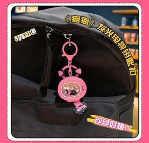 Pink cat TV glowing keychain with sequins and cute cloud charm on black backpack