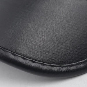Close-up of black leather texture and detailed stitching on the crown of the military hat