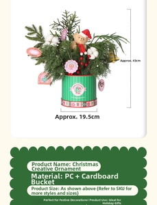 Detailed view of artificial pine branches, cotton, and red berries in a green striped bucket