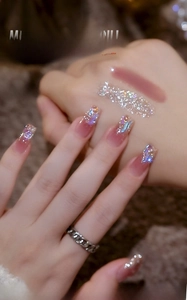 Detailed view of pink aurora mini flat-back crystals applied on manicure nails