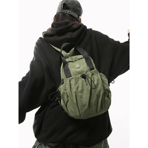Mini army green nylon backpack for women and men showing back view on model