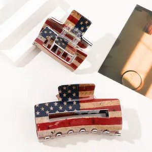 Detail shot of large American flag hair claws with vintage texture and metal spring