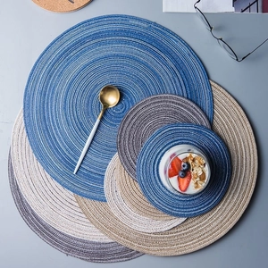Set of round woven cotton placemats in blue, beige, and gray for stylish table heat insulation