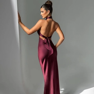 Detail of burgundy satin evening dress featuring a halter backless design with a large bow