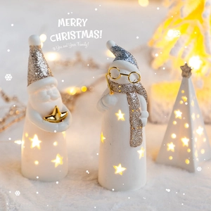 Lighted ceramic Christmas decor featuring Santa, snowman, and star tree with LED lights