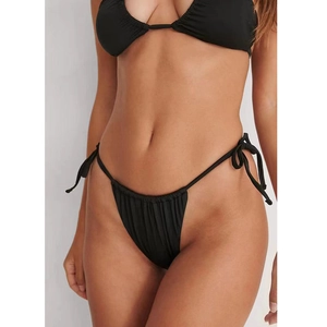 Detail of black bikini bottom with textured fabric and adjustable side tie knots