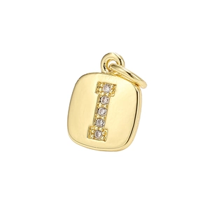 Macro shot of gold-plated square pendant with zircon letter I inlay on white background