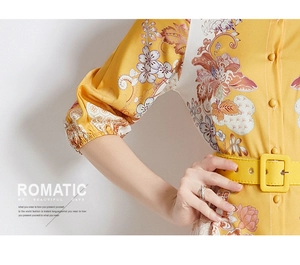 Detailed shot of yellow floral print dress featuring matching belt and buttoned cuffs